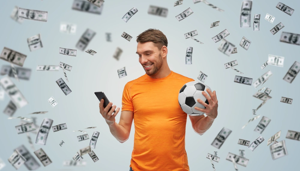 Oranje man gokt op telefoon terwijl het geld om hem heen regent